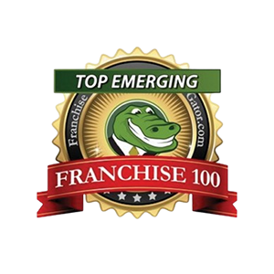 Franchise Gator logo featuring a green alligator in a suit, with a gold seal and ribbons reading "Top Emerging Franchise 100.